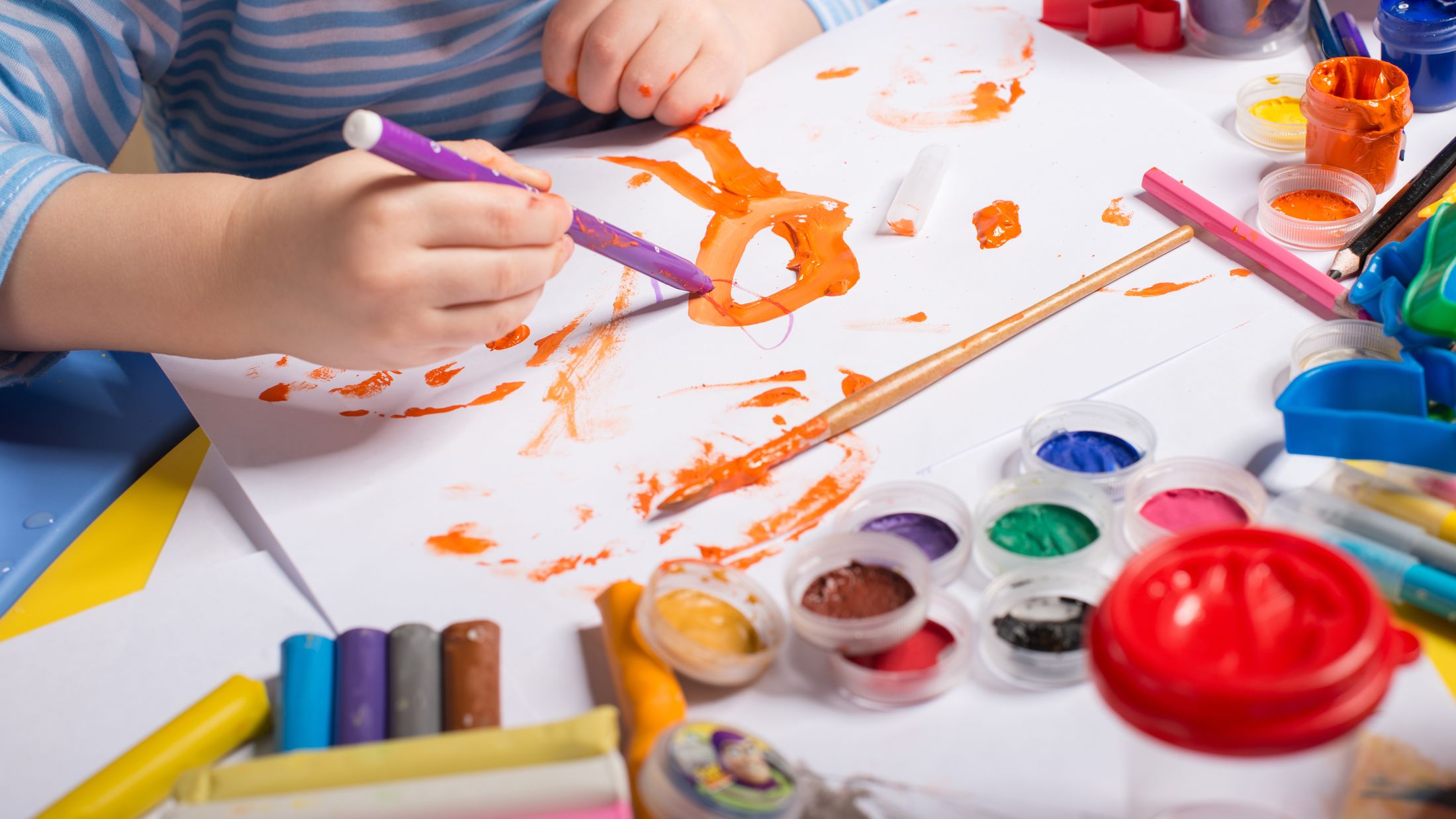 Hands of painting little boy and the table for creativity; Shutterstock ID 132261485; PO: Sovereign