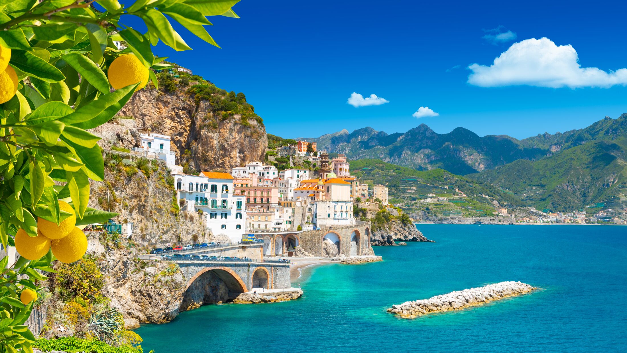 Beautiful view of Amalfi on the Mediterranean coast with lemons in the foreground, Italy