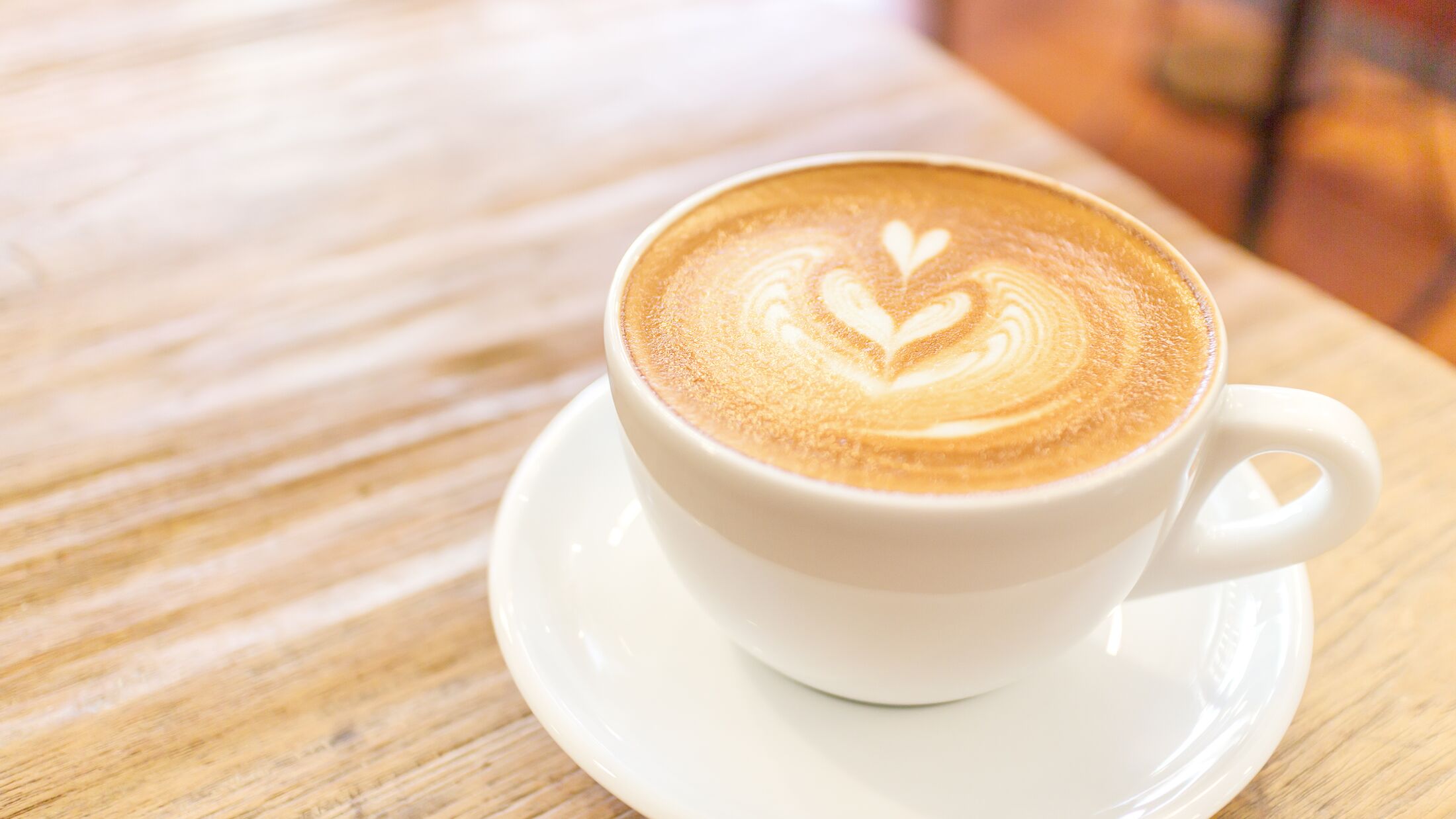 Cup of coffee latte art on wood table