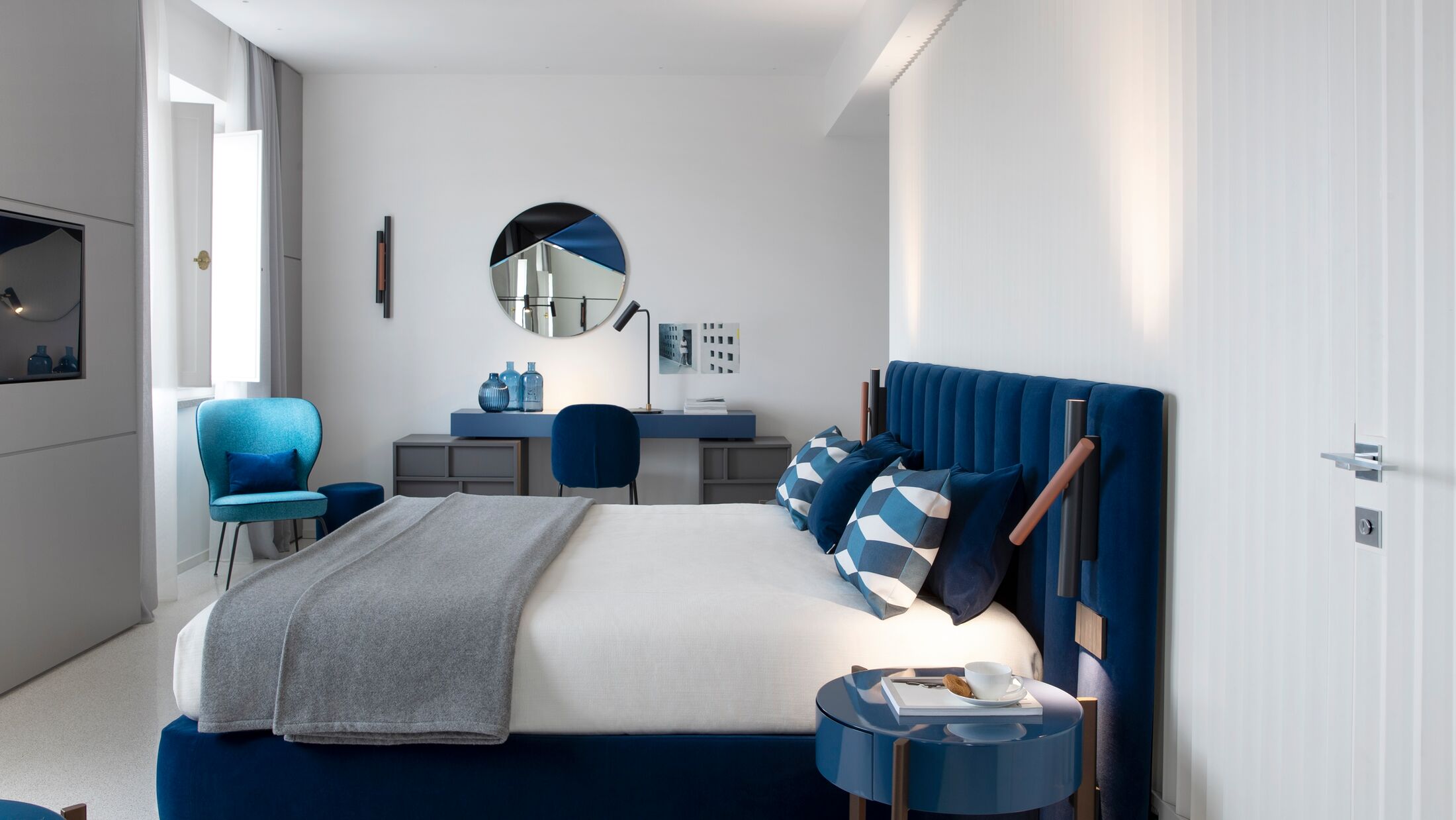 a bedroom with a blue chair