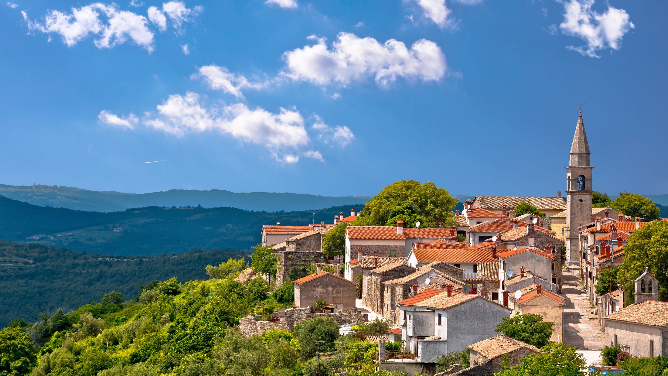 Idyllic hill town of Draguc in green landscape view, inland Istria, Croatia
