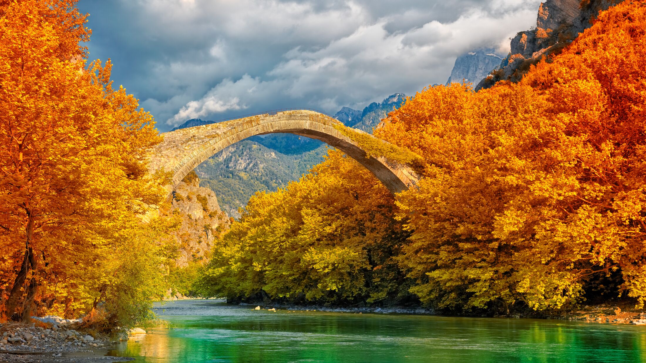 Overcast landscape of Konitsa bridge and Aoos River, Greece.