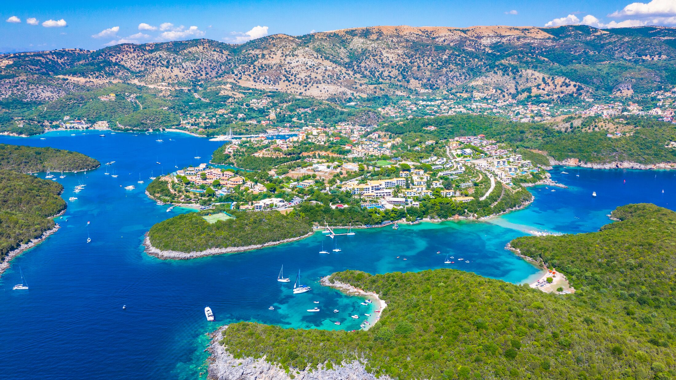 Aerial view of iconic paradise sandy beaches with turquoise sea in complex islands of Agios Nikolaos and Mourtos in Sivota area, Epirus, Greece