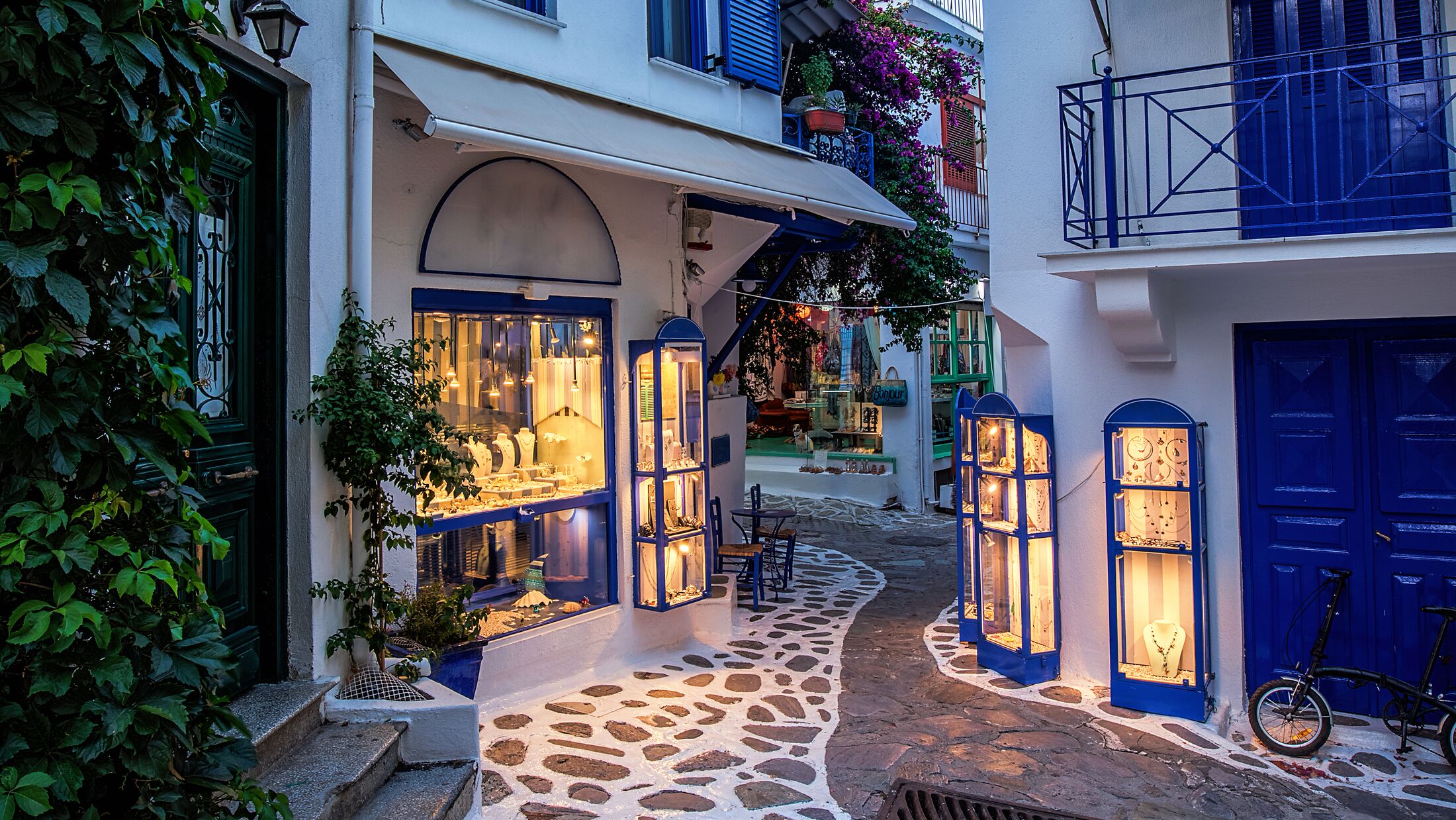 Beautiful old, narrow alley with cobblestone in Skiathos, Greece