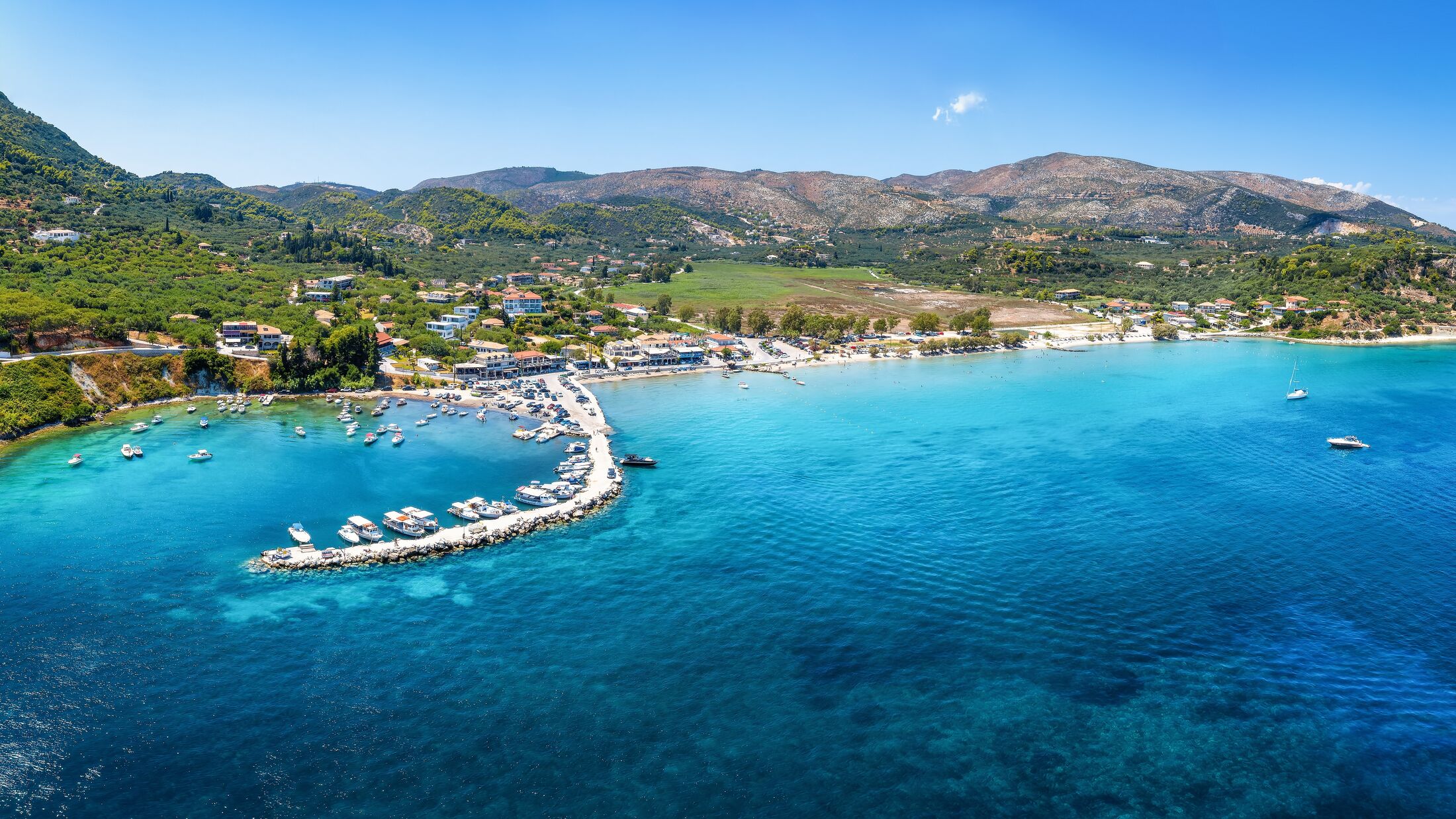 Aerial, panoramic view over the marina to the beautiful village of Limni Keri, bay of Laganas, Zakynthos, Greece