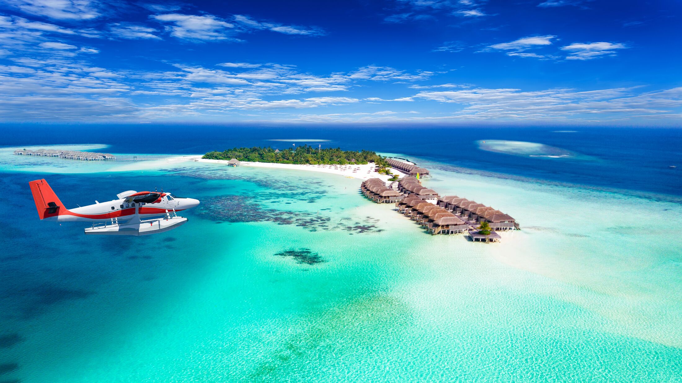 Aerial view of a seaplane approaching island in the Maldives