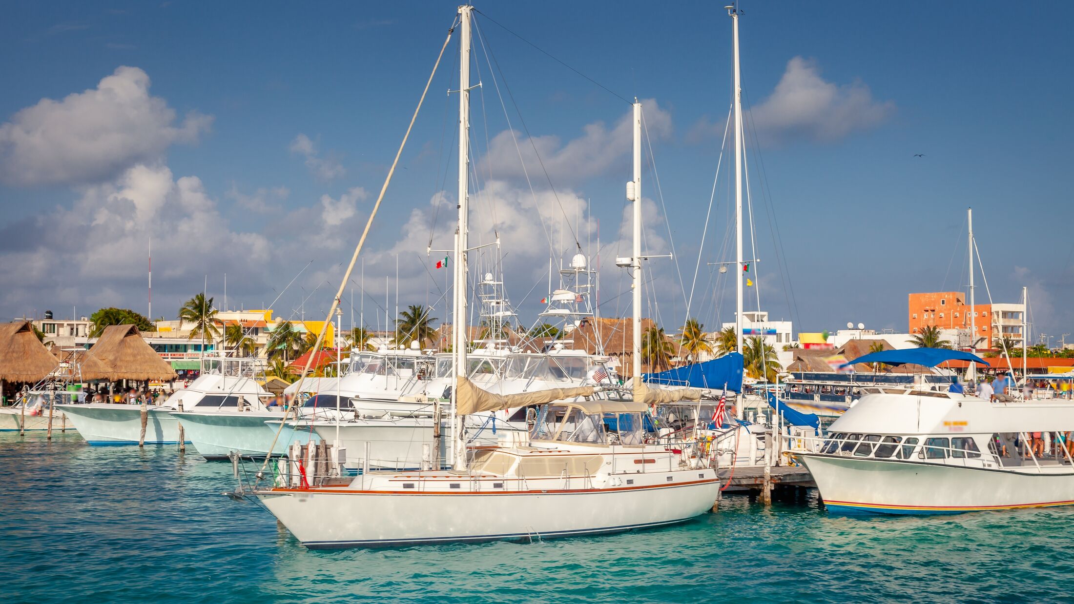 Cancun marina with sailboats, caribbean bach at sunset, Riviera Maya, Mexico