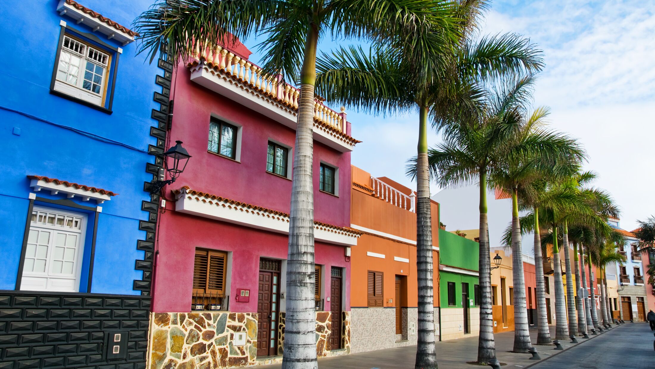 Tenerife. Colourful houses and palm trees on street in Puerto de la Cruz town, Tenerife, Canary Islands, Spain.
