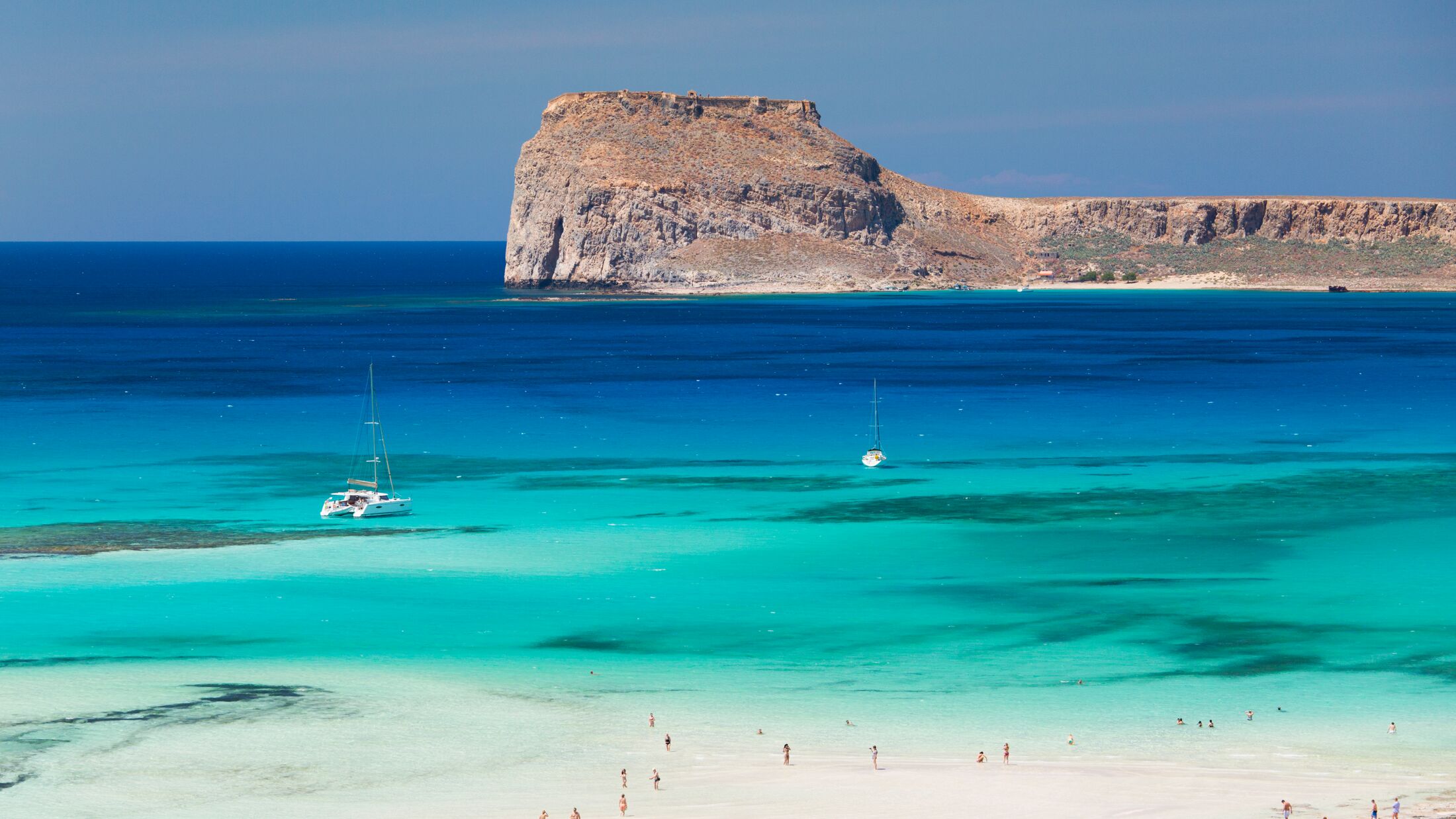 View over Balos Beach and the shallow turquoise waters of the Balos Lagoon to Gramvousa Bay and the island of Imeri Gramvousa, near Kissamos (aka Kastelli), Hania (aka Chania), Crete, Greece, Europe