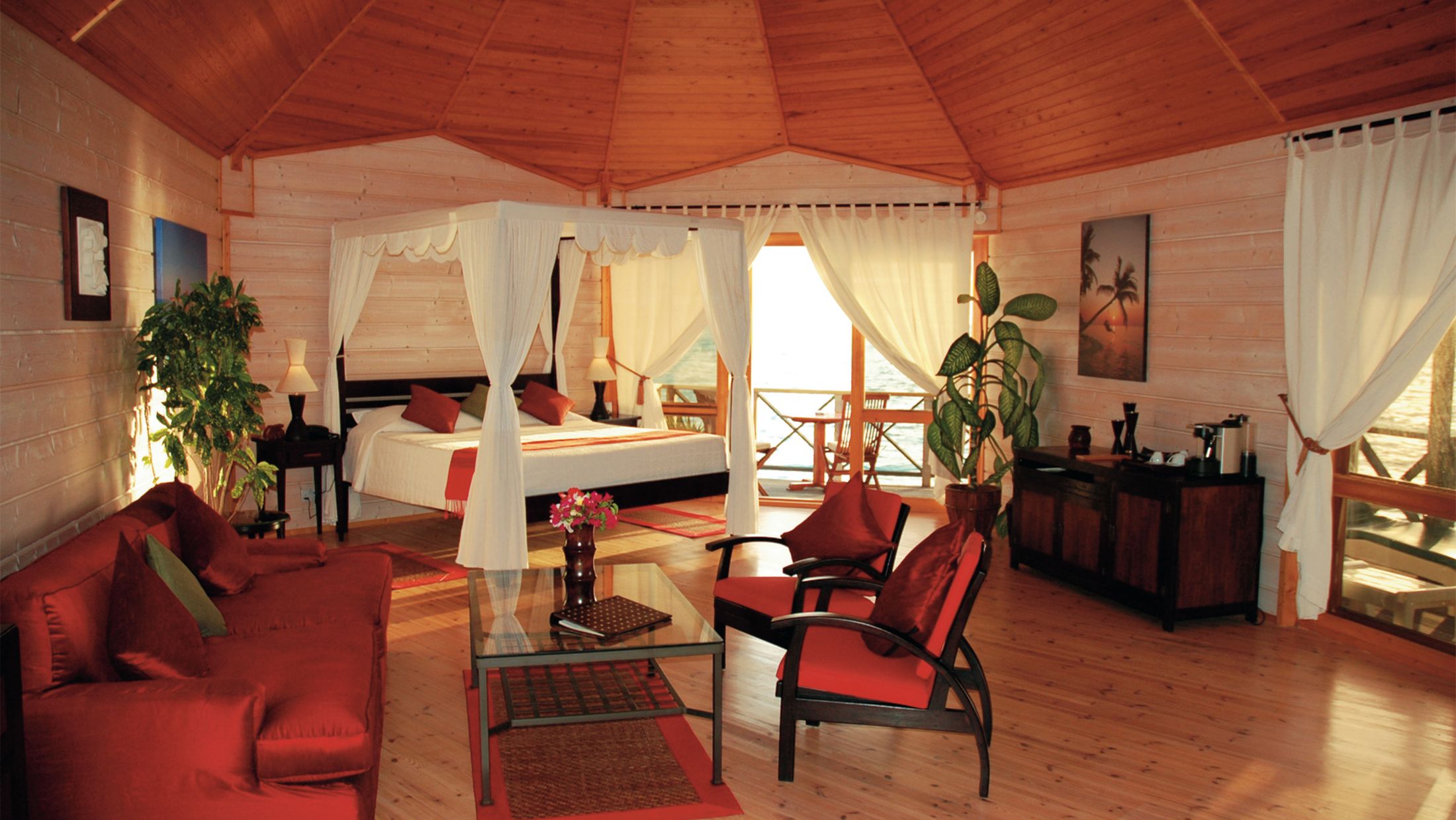 a living room filled with furniture and a red chair