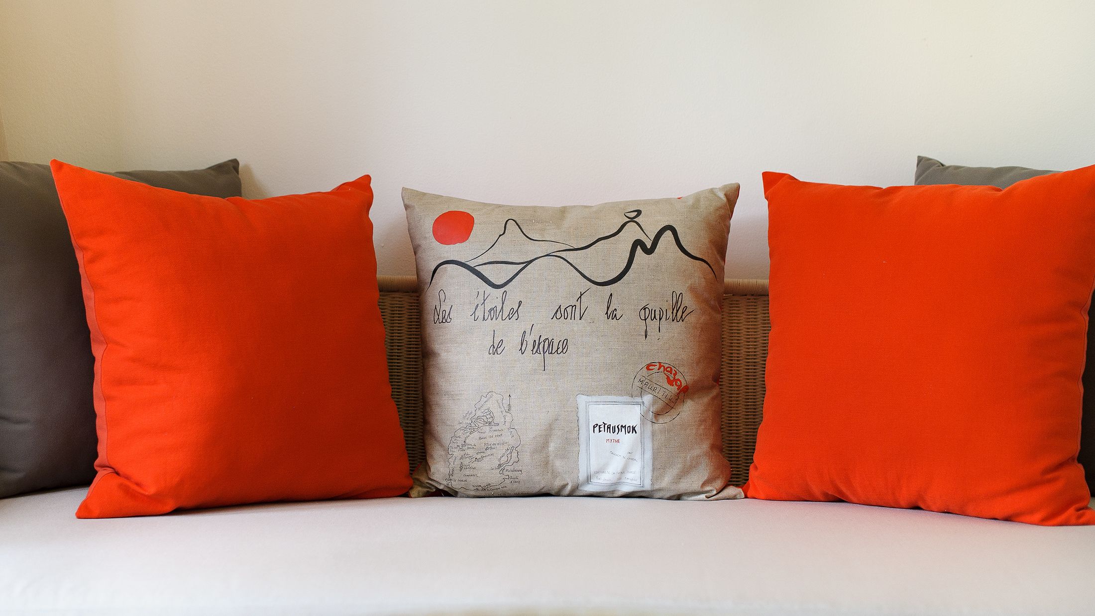 a red pillow on a bed