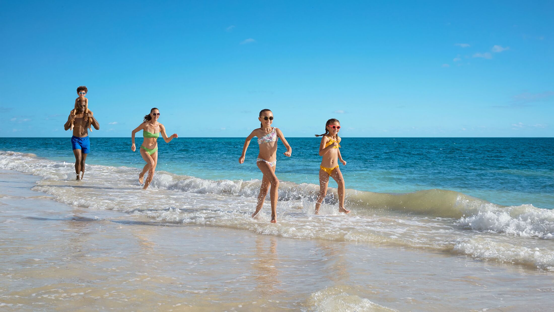 Family on the Beach at Dreams Sapphire Resort