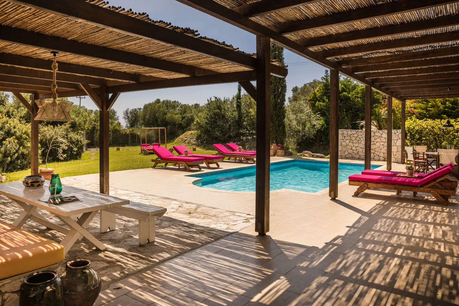 a row of beach chairs and an umbrella