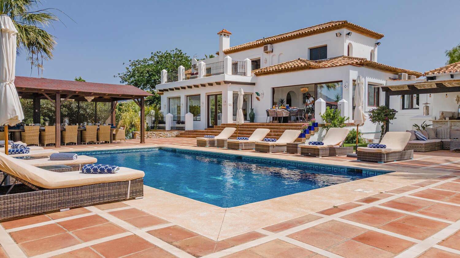a large brick building with a pool in front of a house