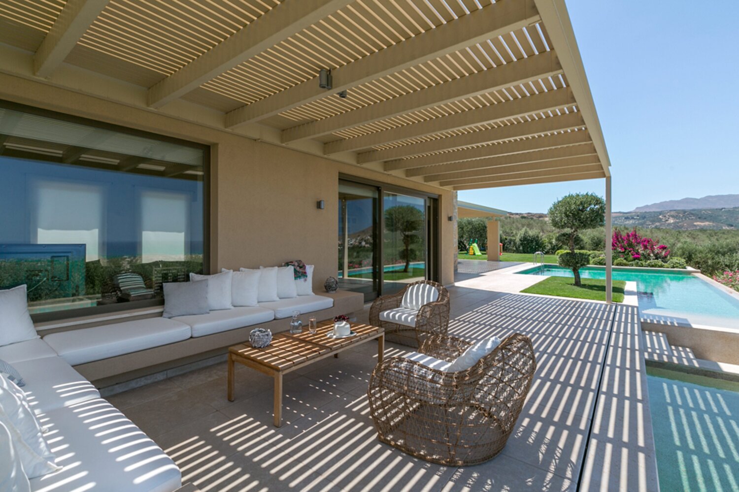A swimming pool at sunset overlooking Crete