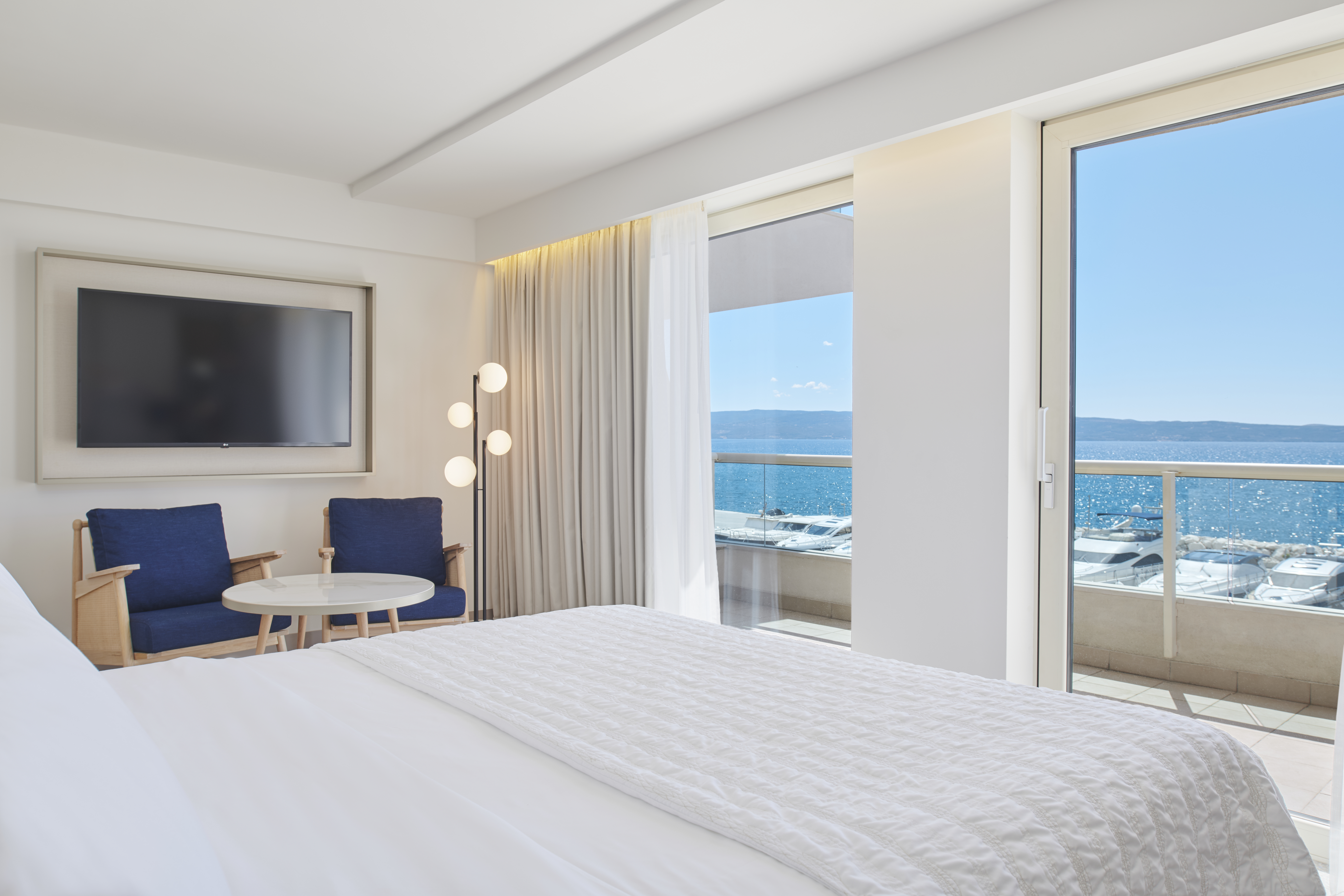 a bedroom with a bed and a large window