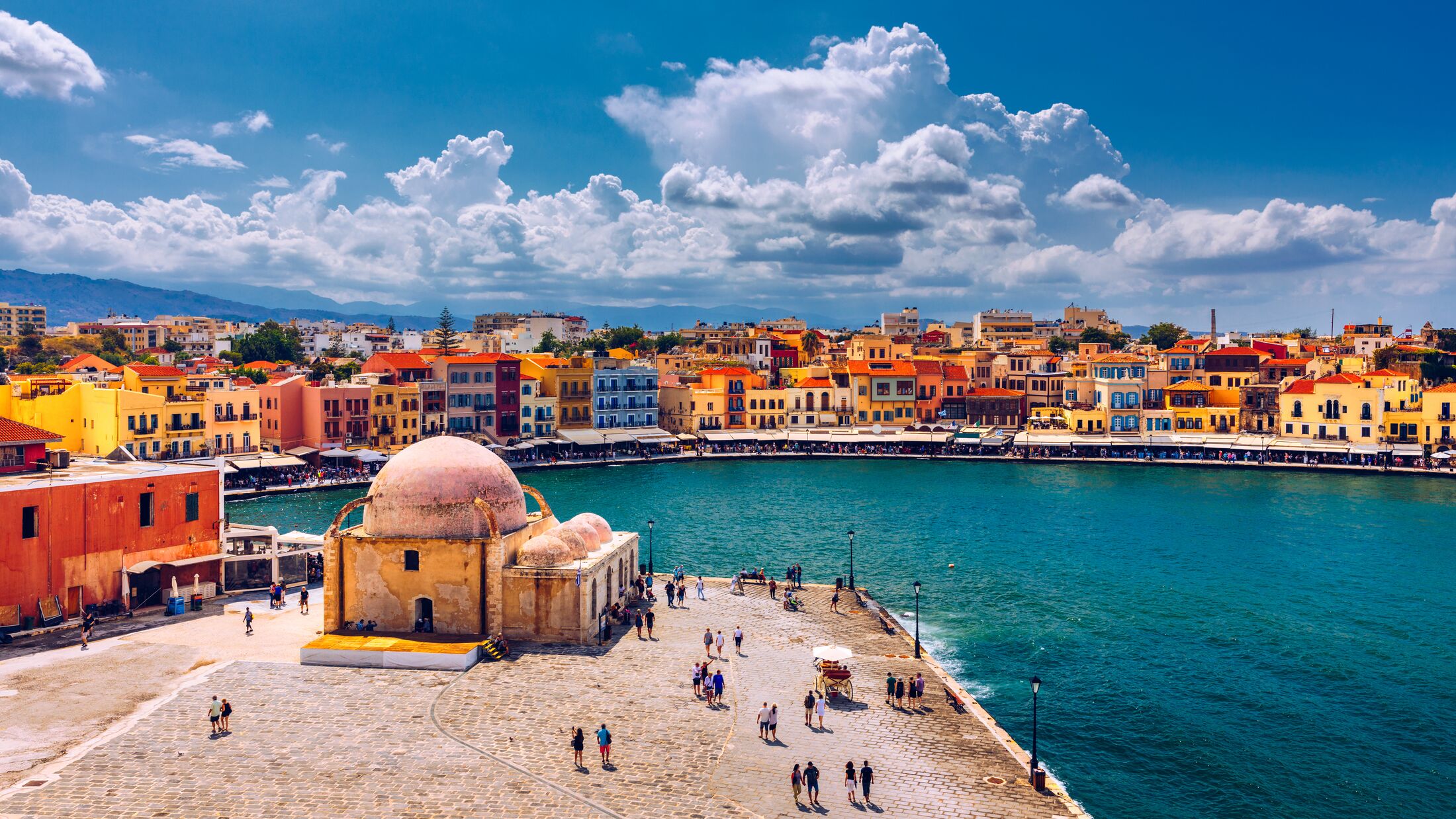 Mosque in the old Venetian harbor of Chania town on Crete island, Greece. Old mosque in Chania. Janissaries or Kioutsouk Hassan Mosque in Chania Crete. Turkish mosque in Chania bay. Crete, Greece.