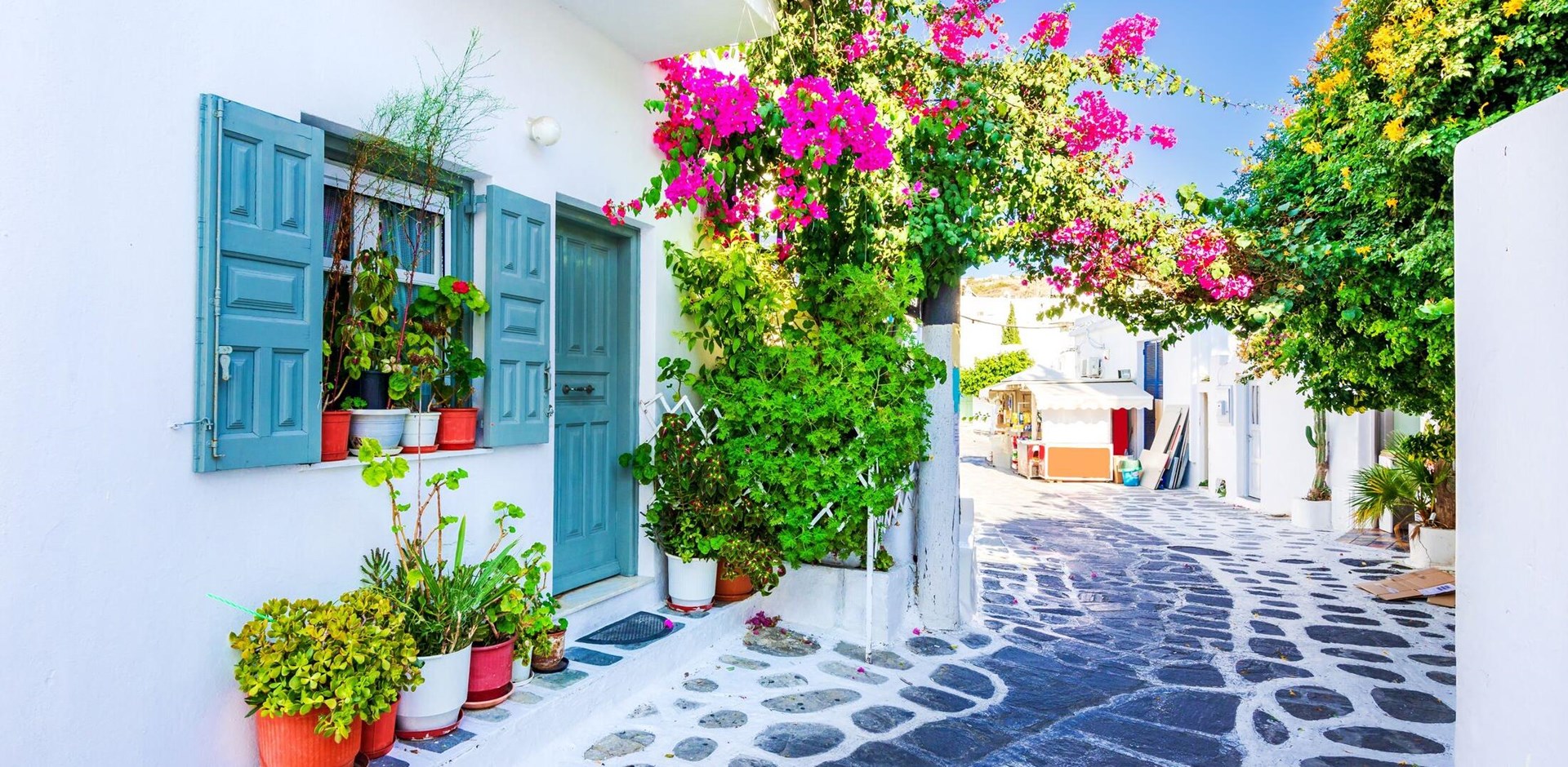Mykonos, Greece. Whitewashed dotted alley in old city Little Venice, Cyclades Greek Islands.