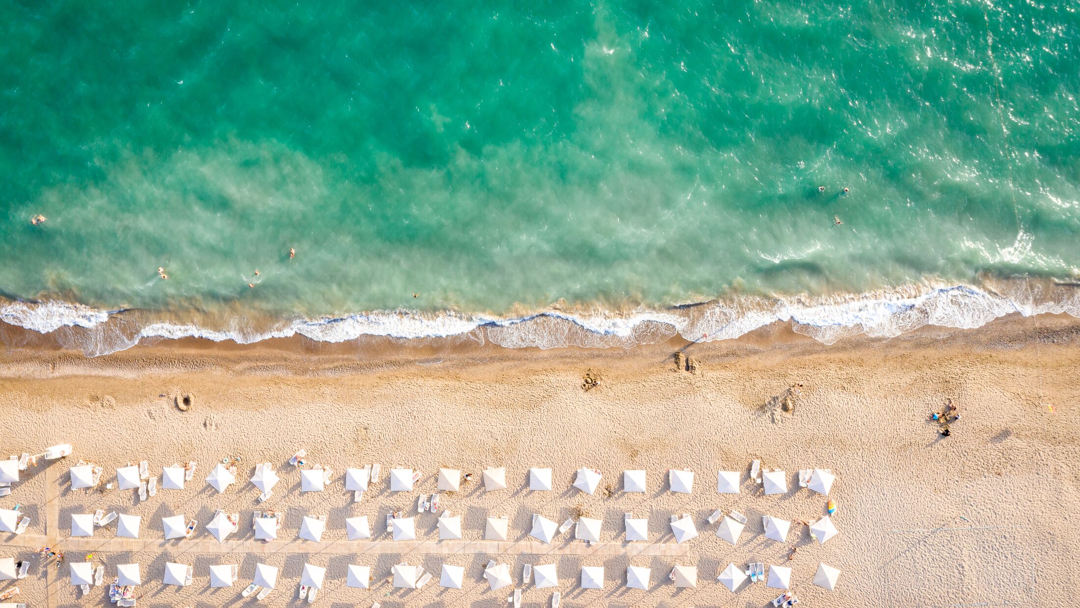 Aerial top view on the beach of Belek, Turkey. Umbrellas, sand and mediterranean sea. Turkish landscape
