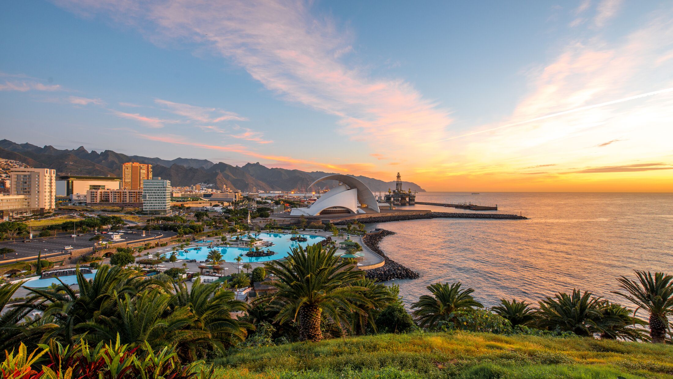 Santa Cruz cityscape view with park, ocean and mountains on the background on the sunrise, Canary islands, Spain