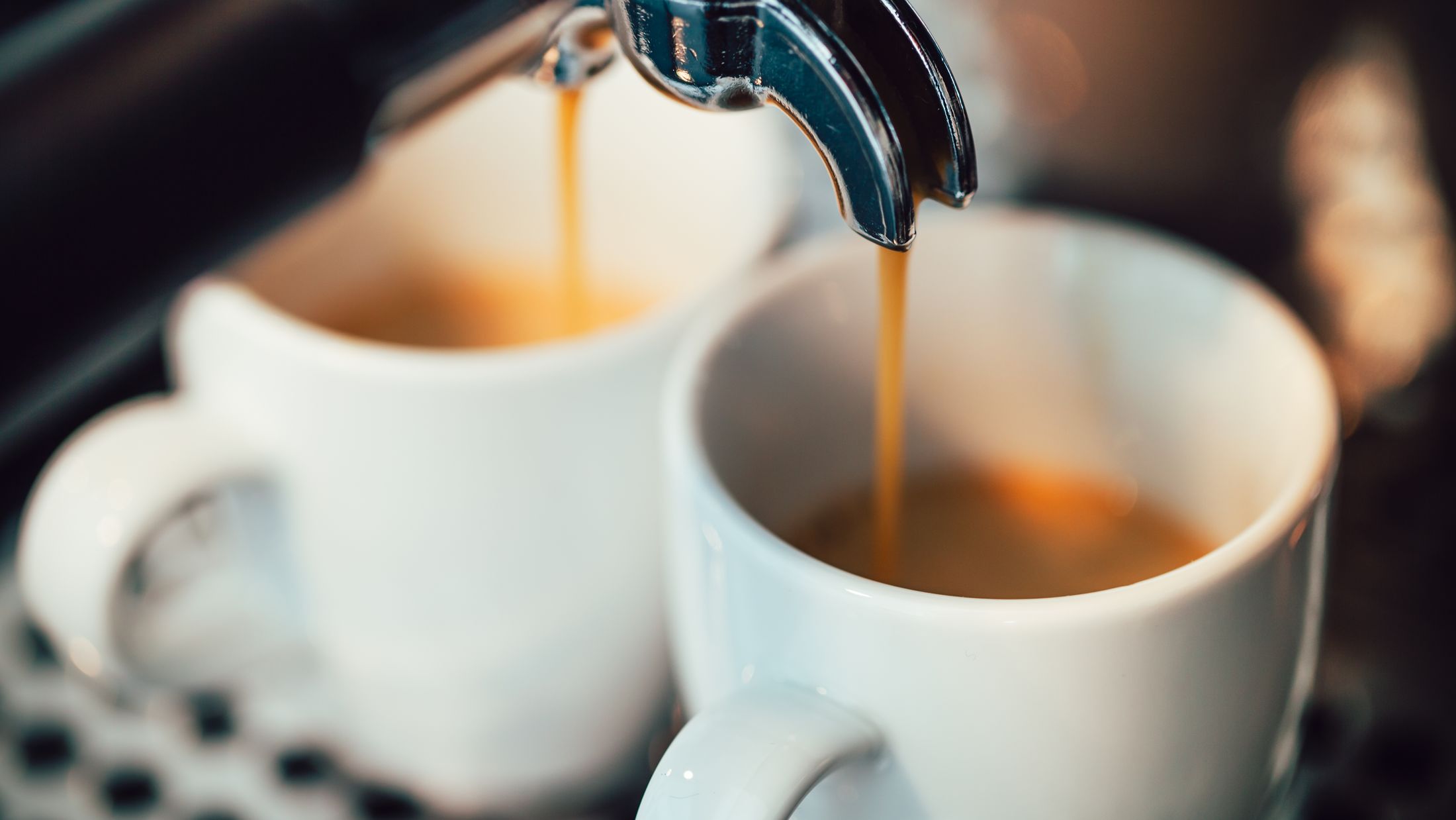 Close up image of espresso pouring into white cups; Shutterstock ID 386462938; PO: Project Italy - Facilities images; Job: Project Italy - Facilities images; Client: H&J/Citalia