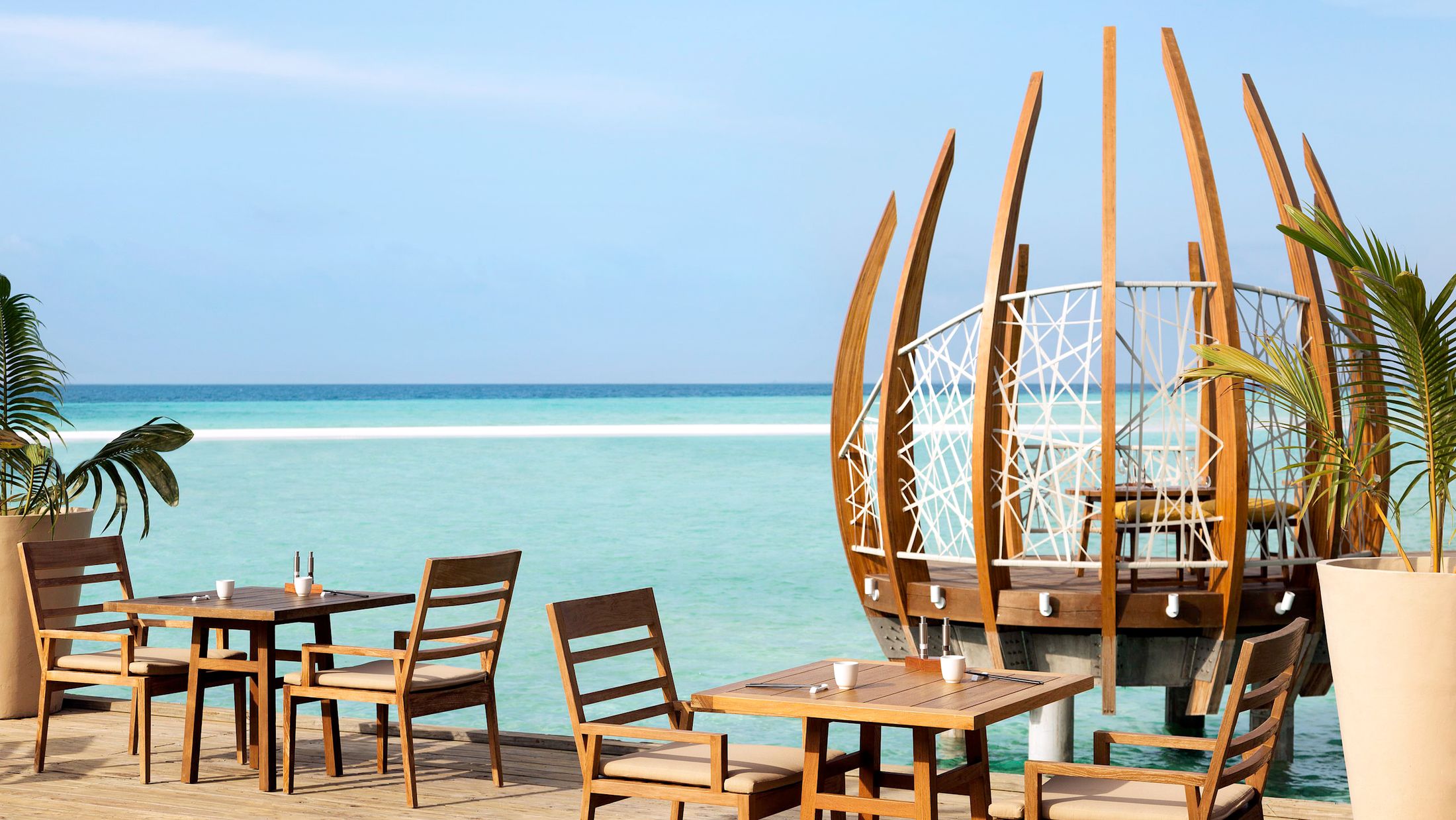 a couple of lawn chairs sitting on top of a wooden table