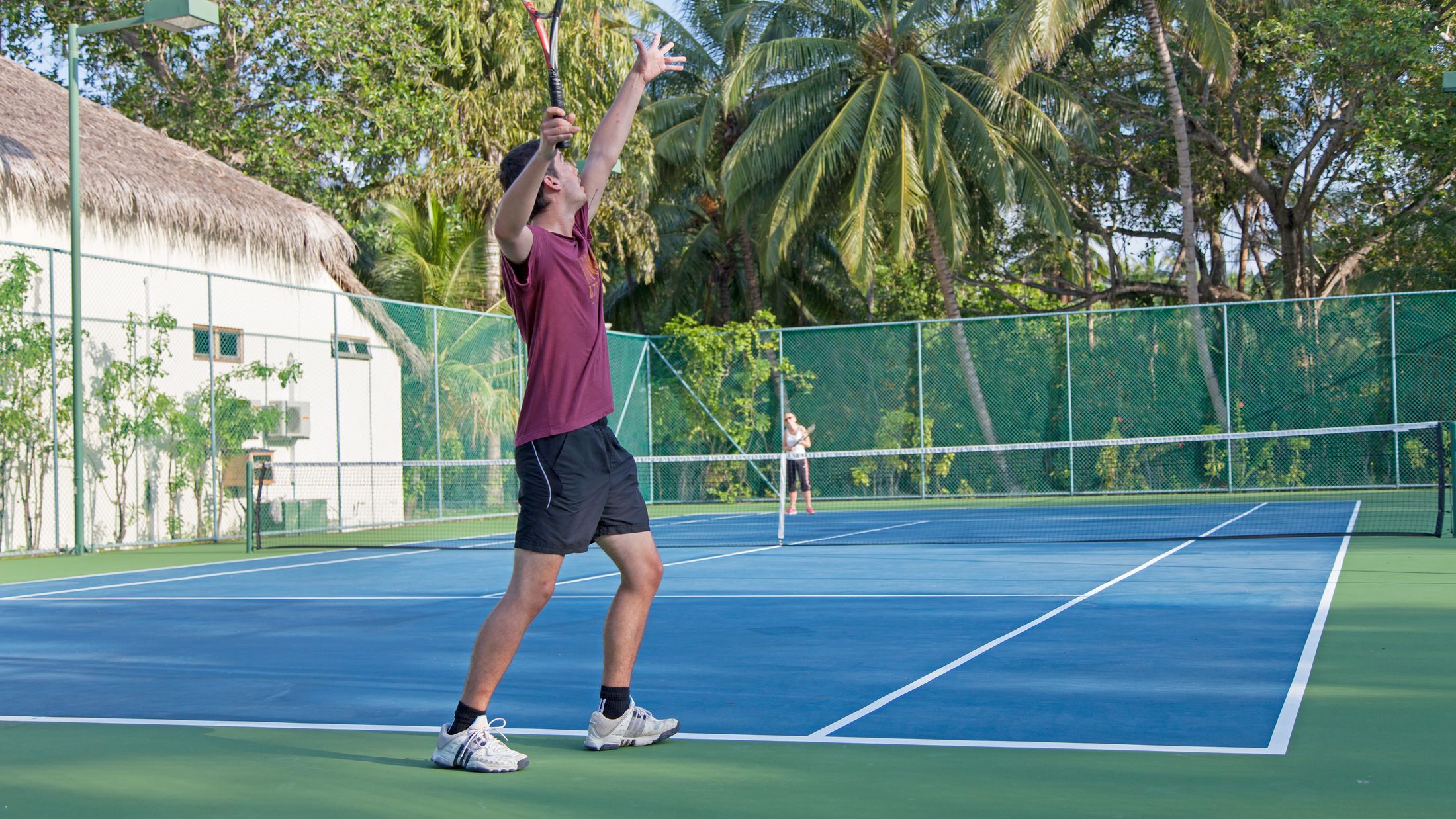 a man holding a racket on a court