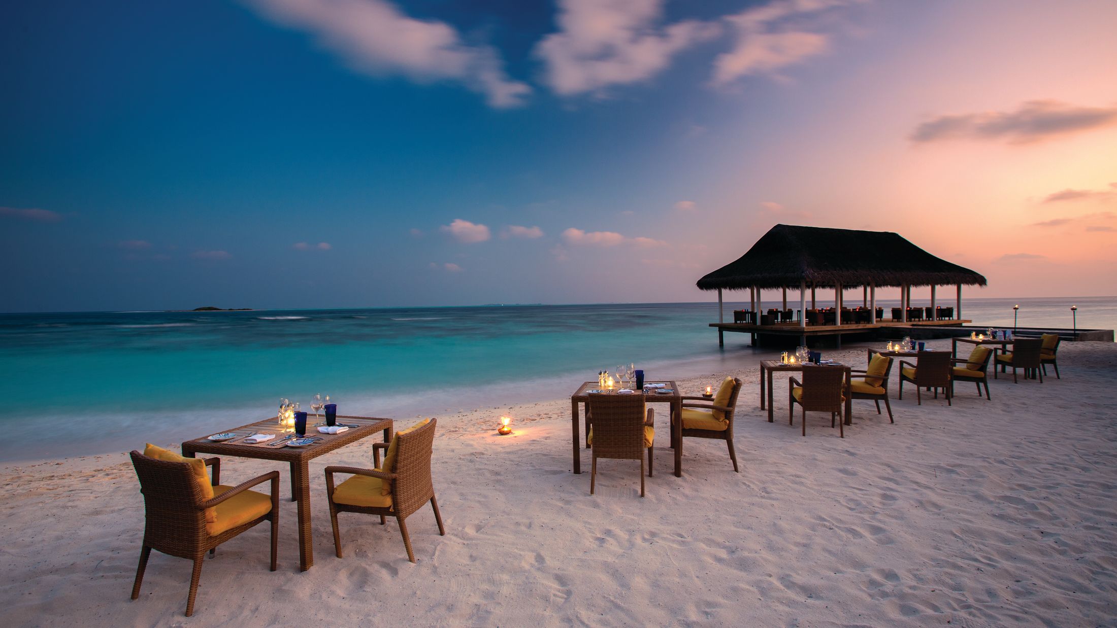 an umbrella sitting on top of a sandy beach next to the ocean