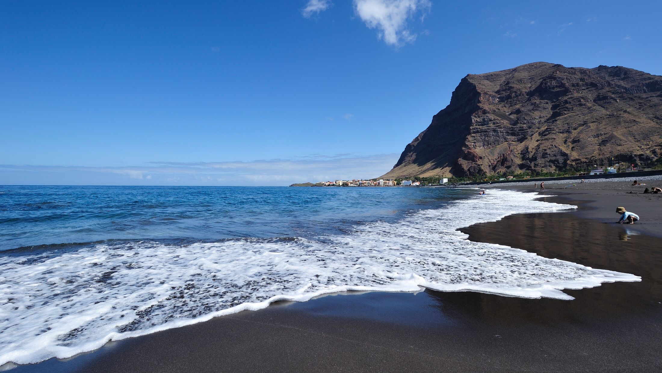 a body of water with a mountain in the background