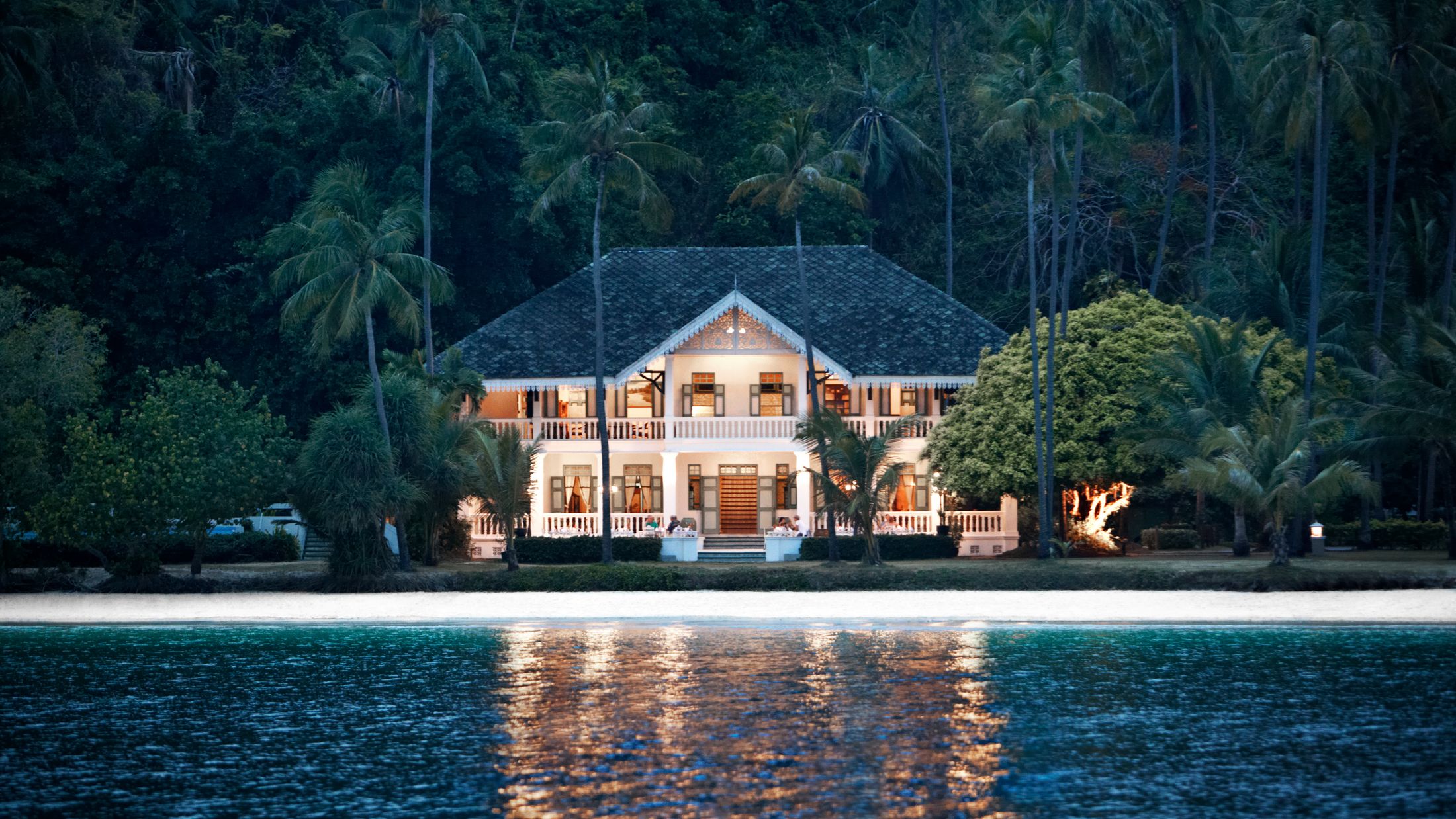 a house next to a body of water