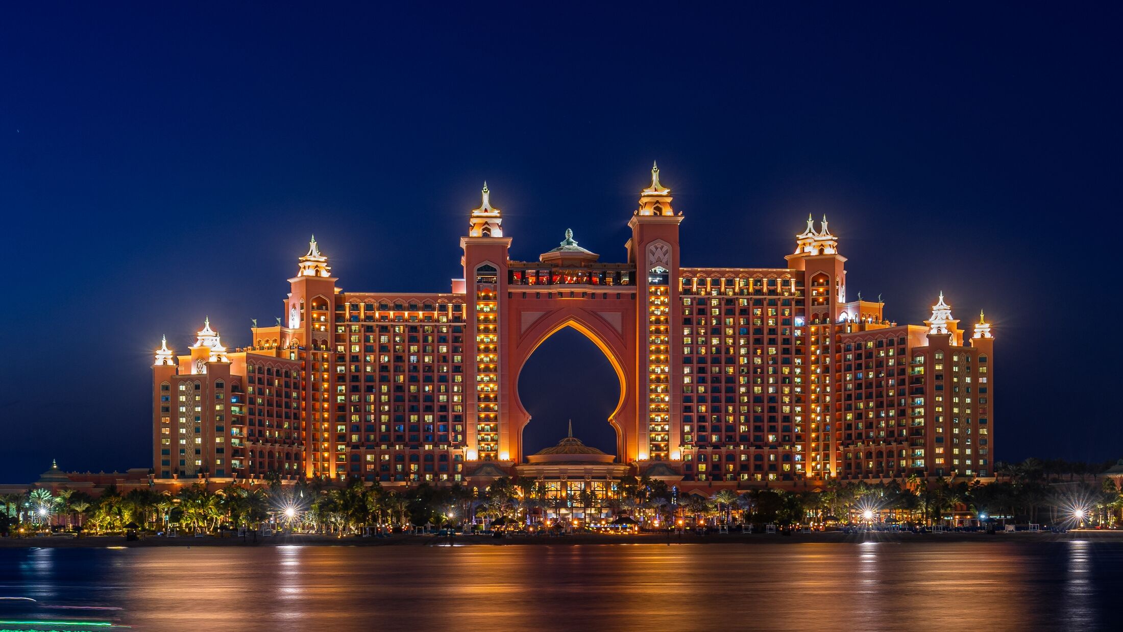 Experience the magic of Dubai's Atlantis hotel at night with our stunning landscape photograph. The iconic hotel, located on the man-made island of Palm Jumeirah