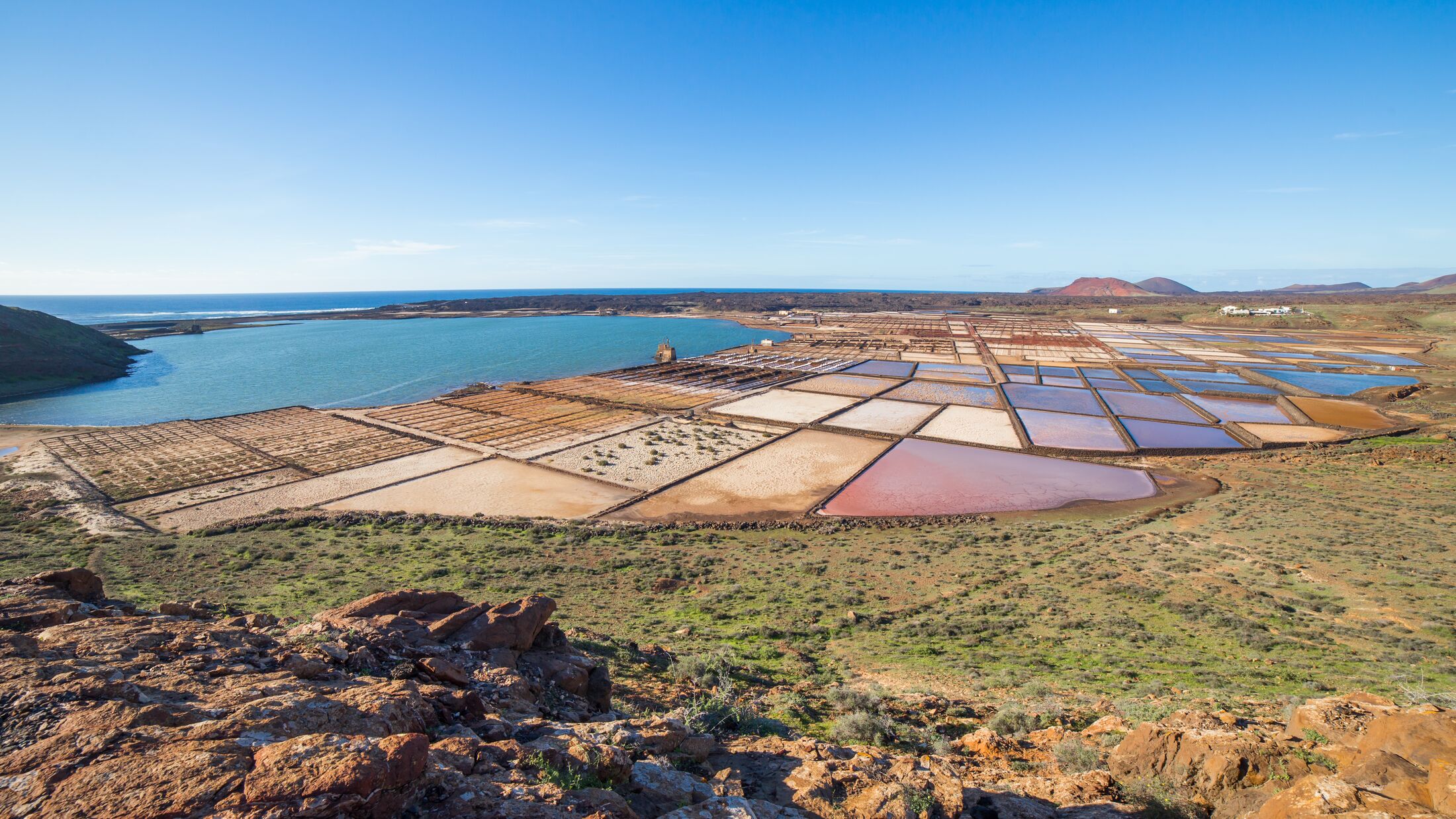 Playa de Janubio, behind which are Las Salinas de Janubio, salt pans from where sea salt is extracted, in Lanzarote, Canary Islands, in Spain